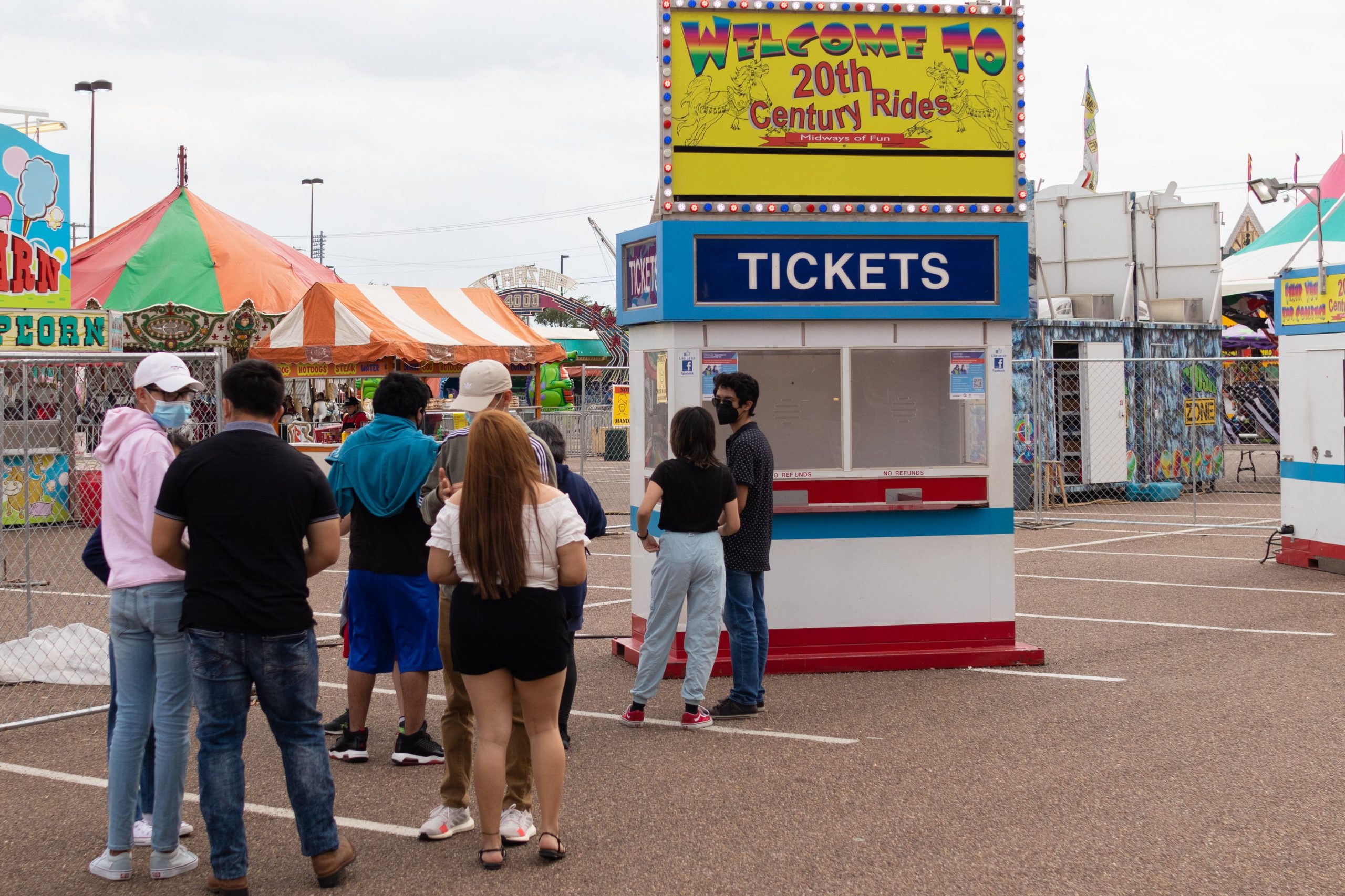 Carnivalgoers wait in line to purchase tickets