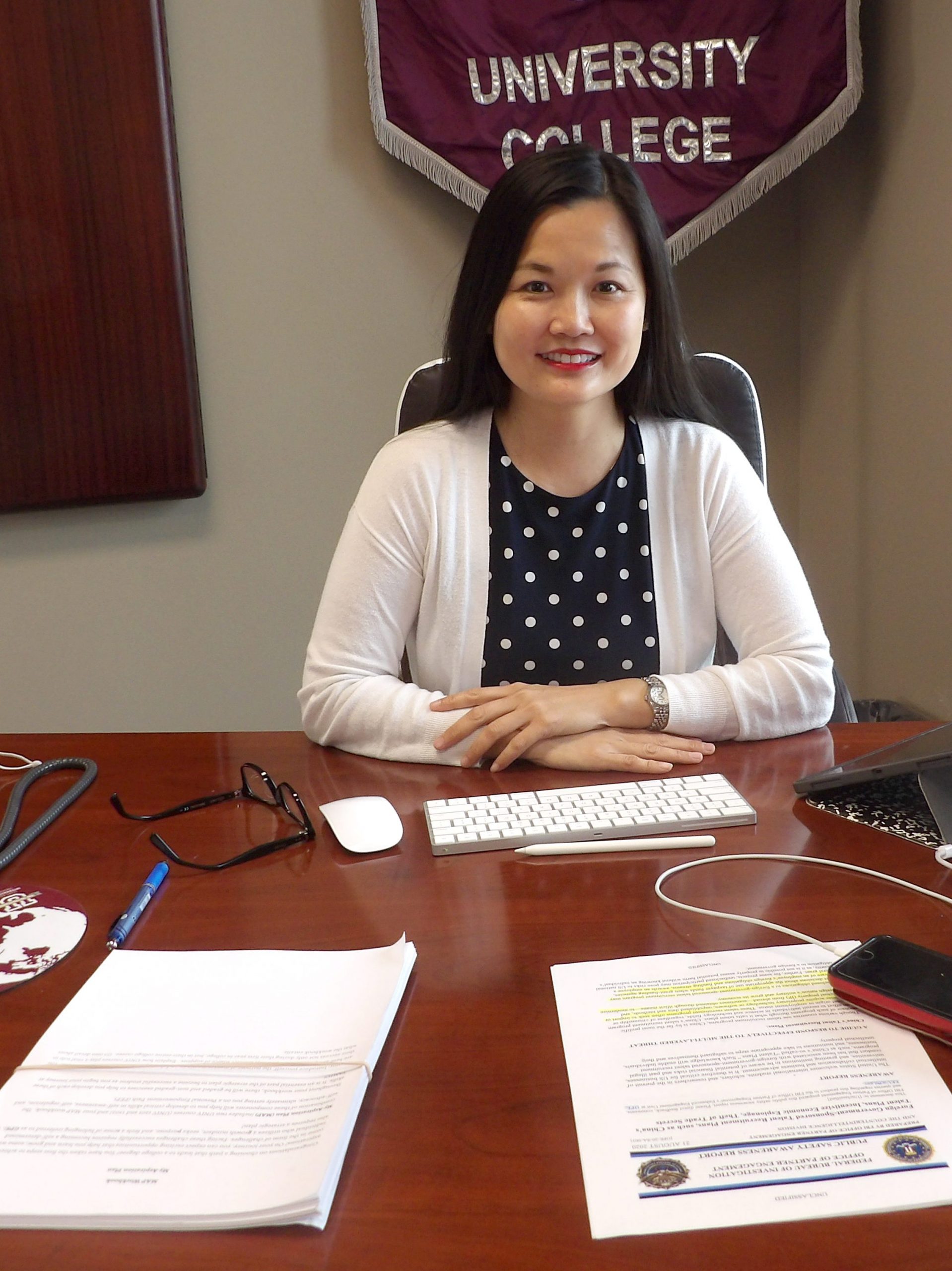 Dean Barbara Hong at her office desk