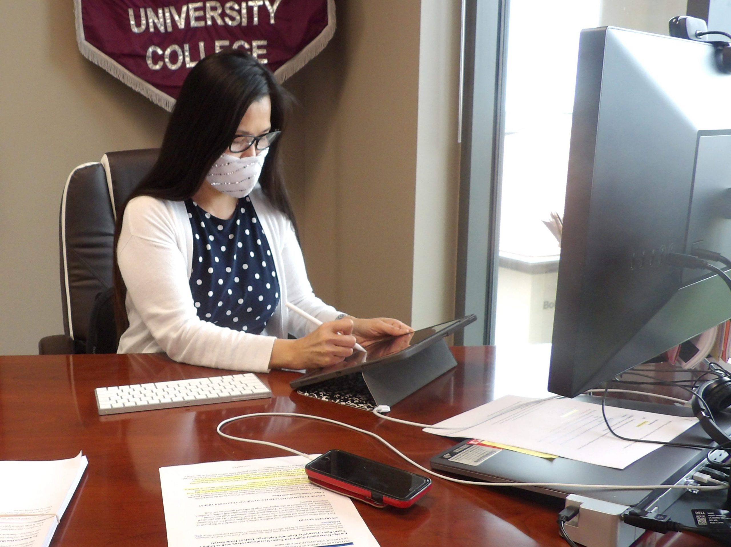 Dean Barbara Hong works in her office.