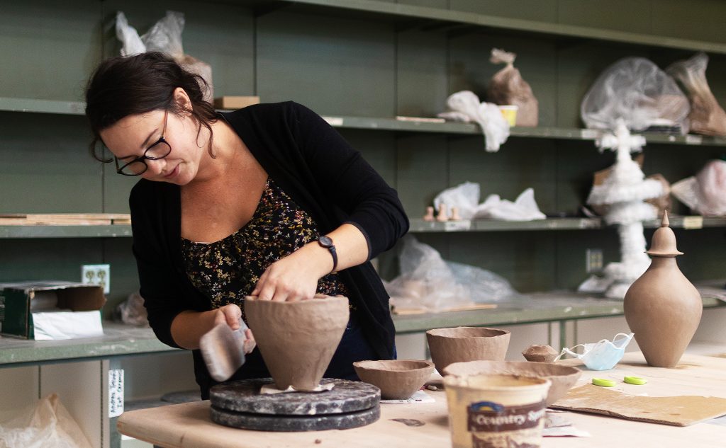 Assistant Professor Bayless works with clay.