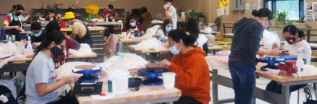 Students work on ceramics.