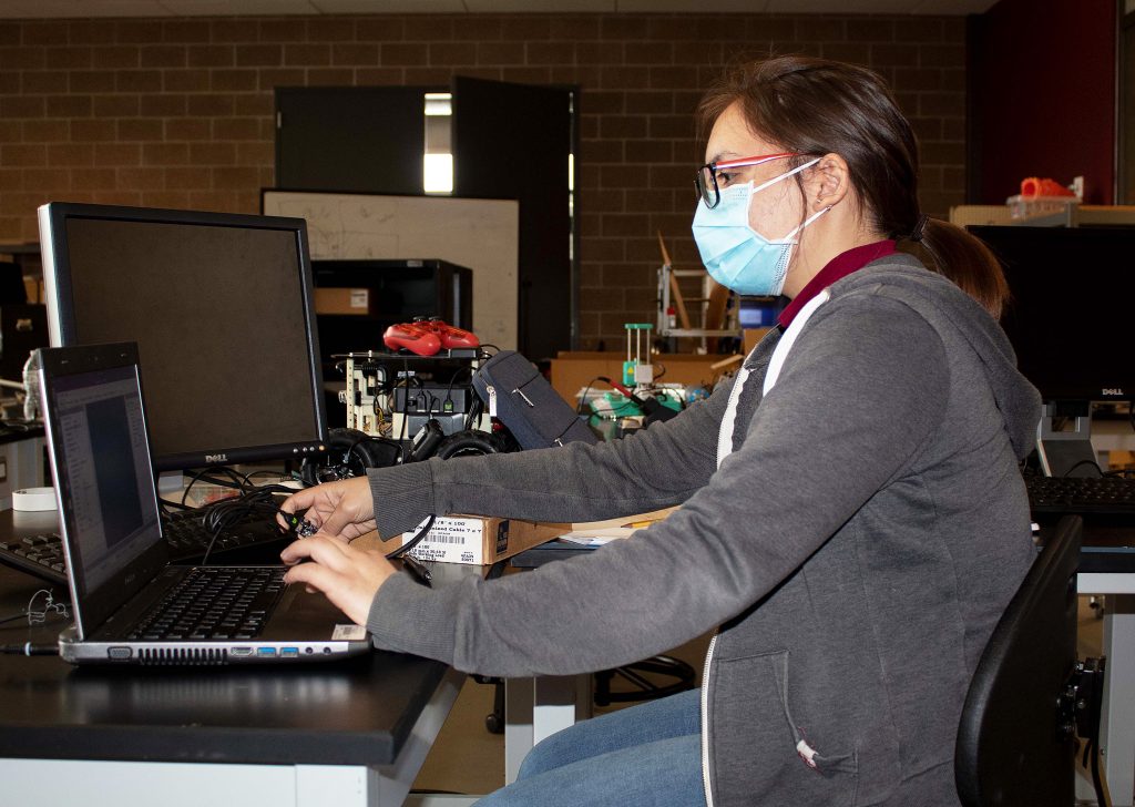 Senior Rosalinda Pescina works on coding
