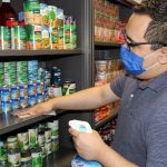 Cleaning the shelves of Dusty's Food Pantry