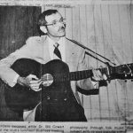 Former President Cowart plays the guitar in a newspaper file image