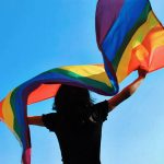 A student waves the pride flag.
