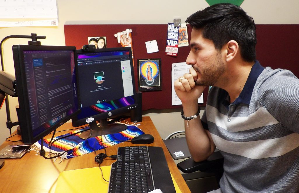 Assistant Professor Arthur Soto-Vasquez looks over research on the computer.
