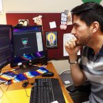 Assistant Professor Arthur Soto-Vasquez looks over research on the computer.