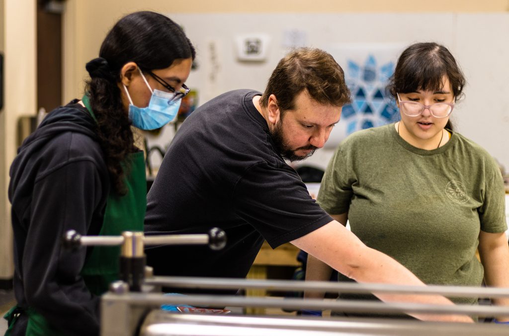 Professor Shaw works with students