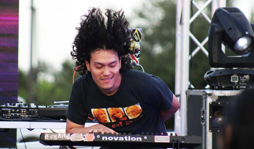 keyboardist whips his hair during performance