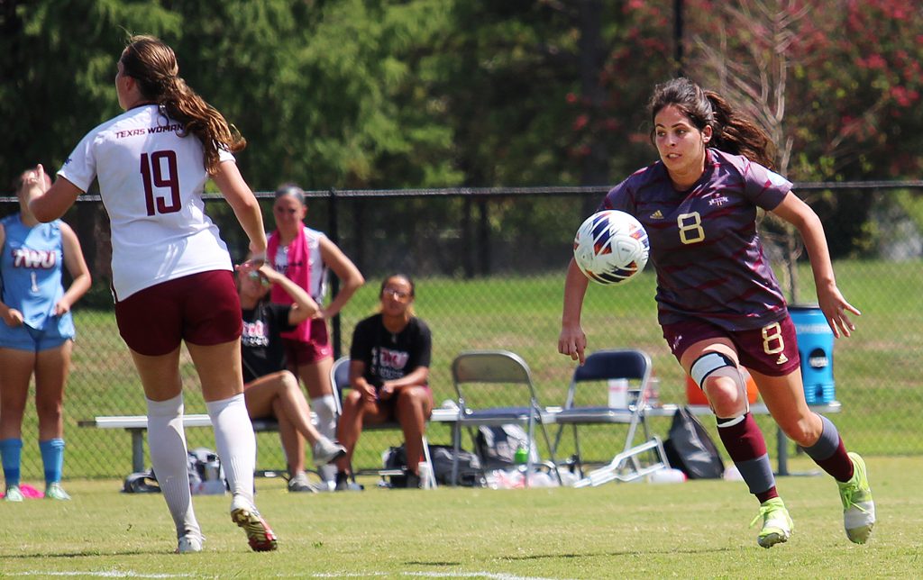 women's soccer competes on the field