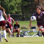 women's soccer competes on the field