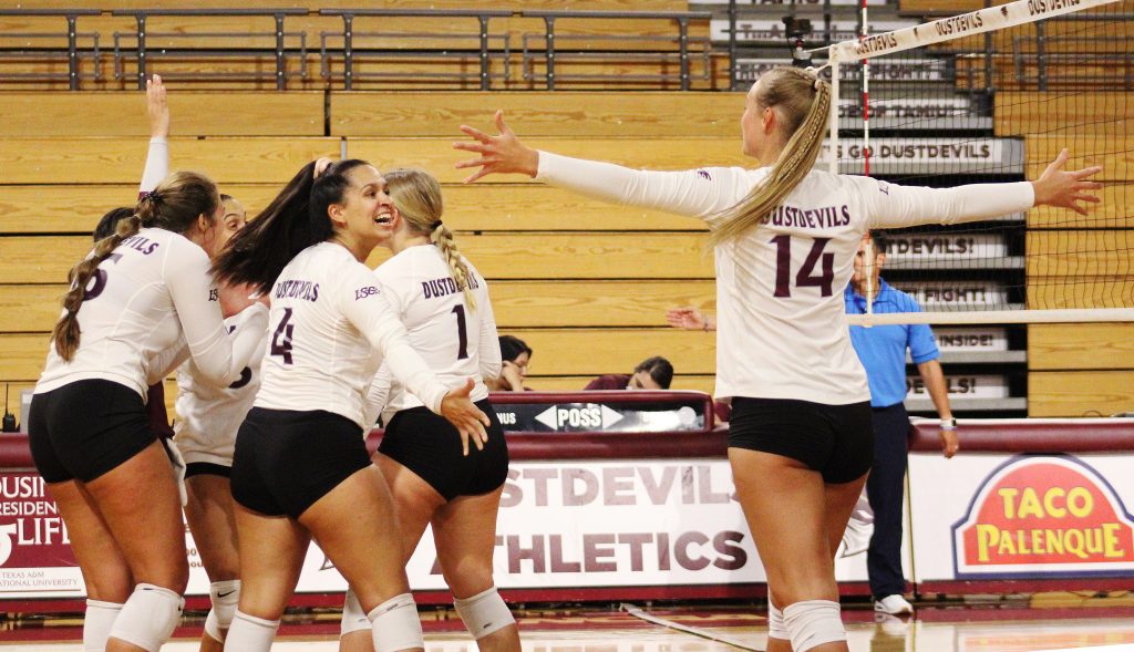 TAMIU volleyball team celebrating a point