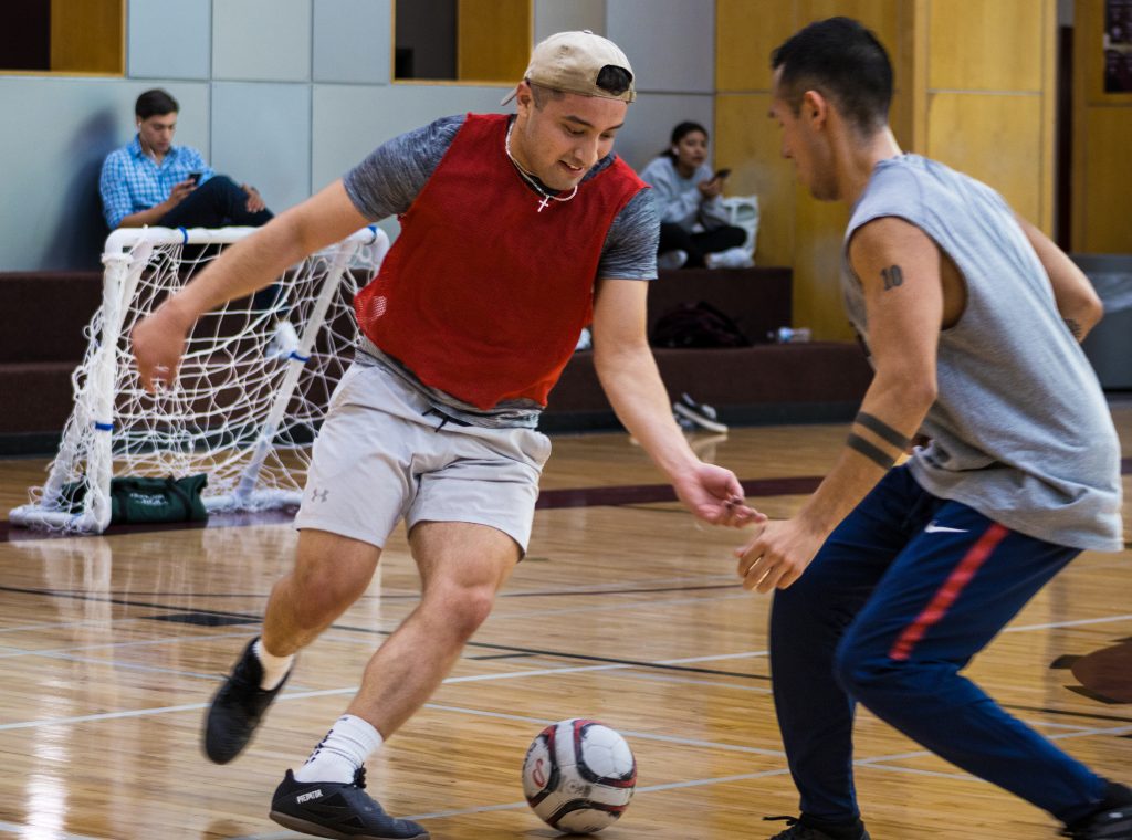 two competitors play indoor soccer