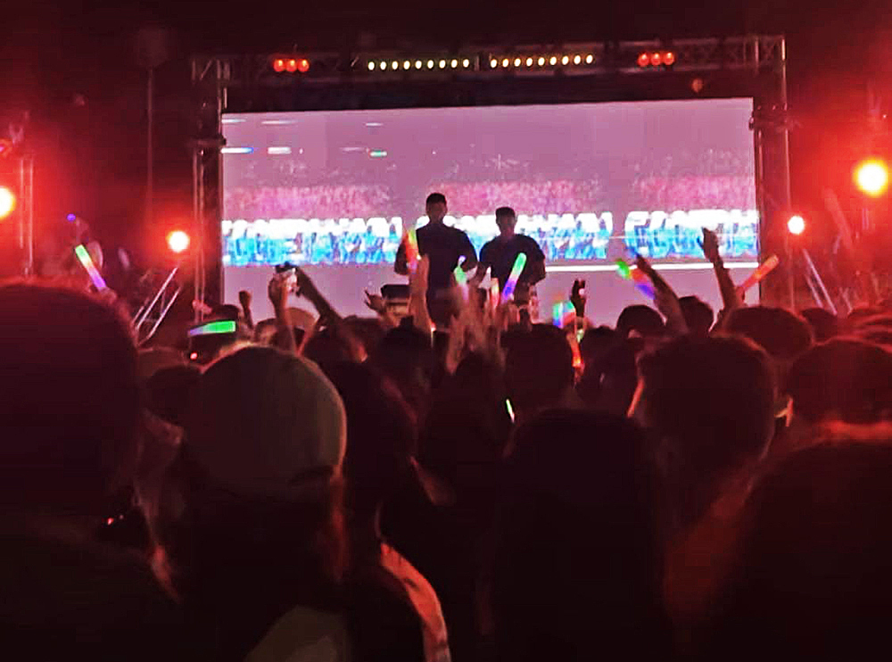 Students listen as bands perform.