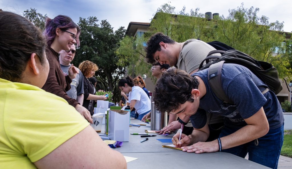 Students fill out messages during the Reading the Globe event.