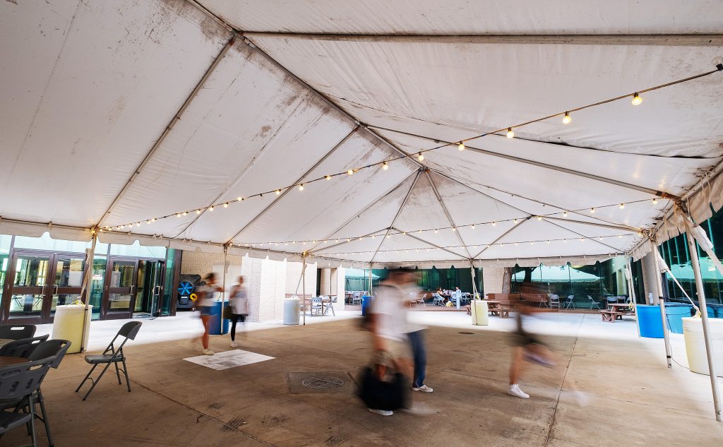 Students walk under the tent-covered patio at the Student Center.