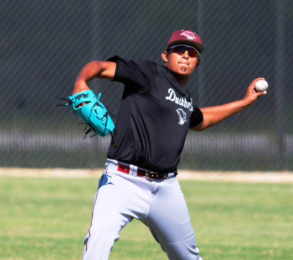 TAMIU outfielder Christopher Sauceda throws the ball.