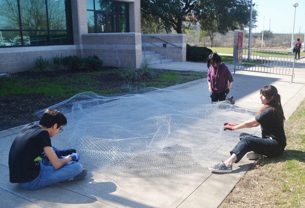 Wagner works with students on the Rhizome project.