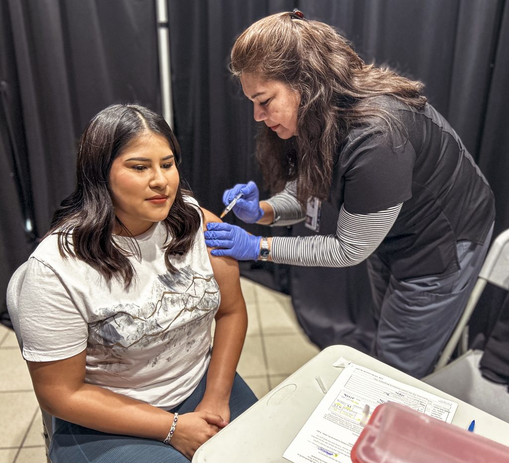 A student gets a flu shot.