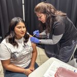 A student gets a flu shot.