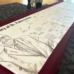 A banner bears signatures and memories from students to remember President Pablo Arenaz