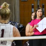 New volleyball coach leads the team during a game