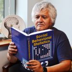 Professor reads his new research book.