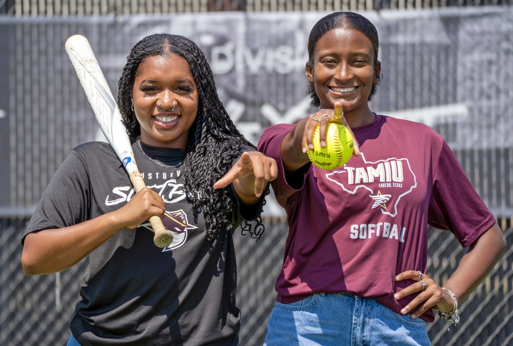 Players Queenandra Dunn (left) and Zakayia Fredrick pose for a softball portrait.
