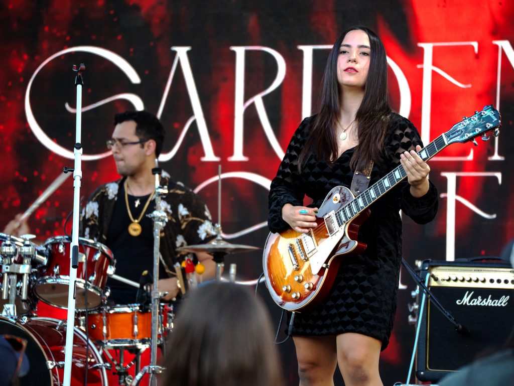Guitarist plays with a band during CABchella event.