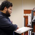 Student looks at a book at the TAMIU Bookstore.