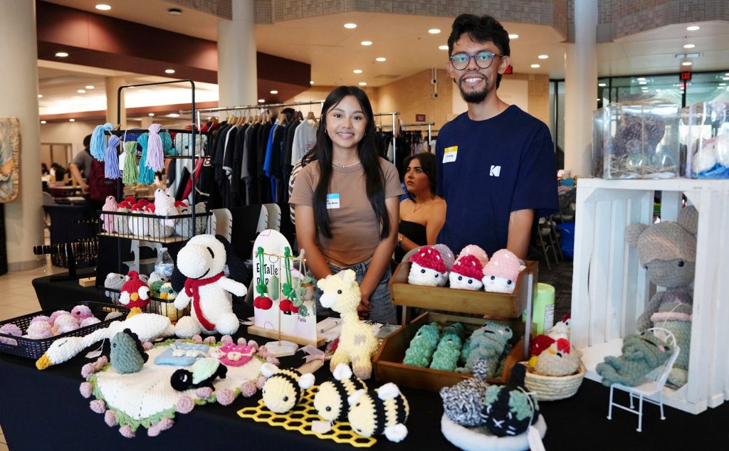 Vendors from a crochet booth, pose for a portrait during the El Mercadito market event.