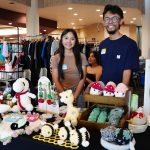 Vendors from a crochet booth, pose for a portrait during the El Mercadito market event.