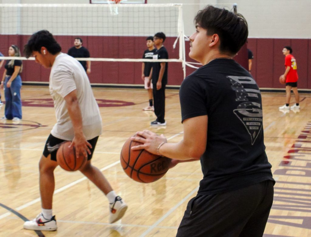 Students compete in intramural sports with basketball in the gymnasium.