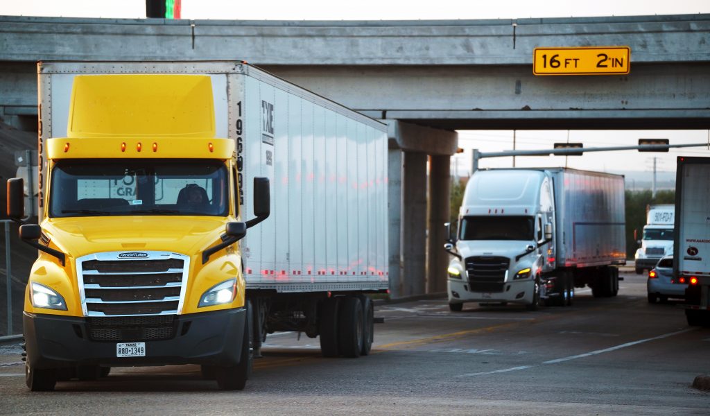 Traditional diesel-powered tractor-trailers travel down I-35 in Laredo, Texas.
