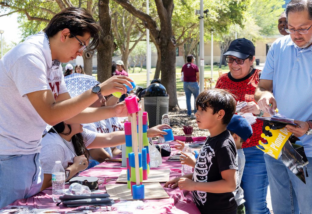 Students and visitors play a game during the Discover TAMIU event.