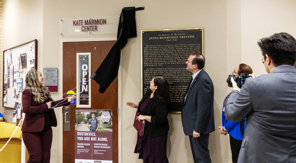 Several people stand around as the new name for the counseling center is revealed.