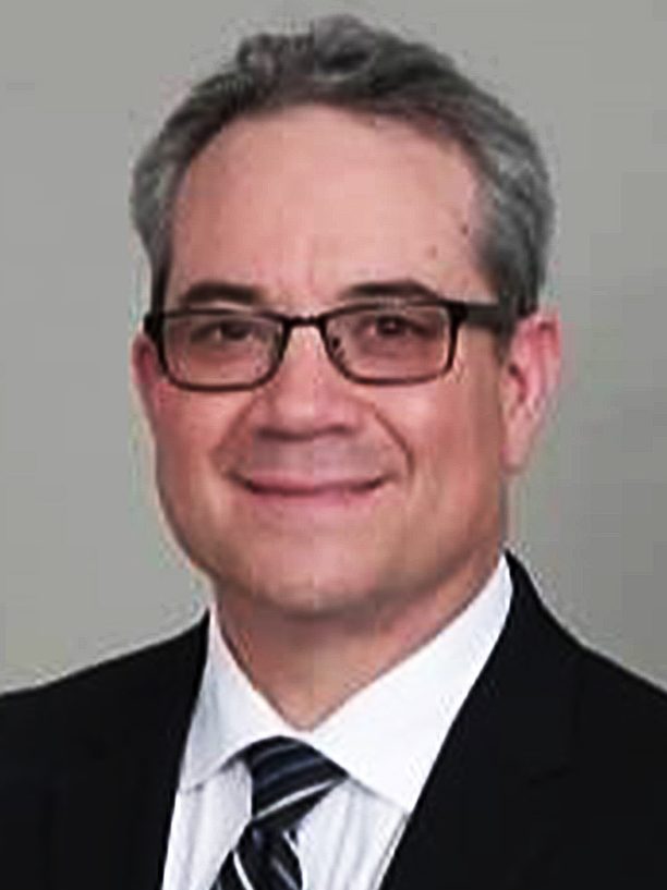 portrait of Javier L Zambrano in a suit with a tie.