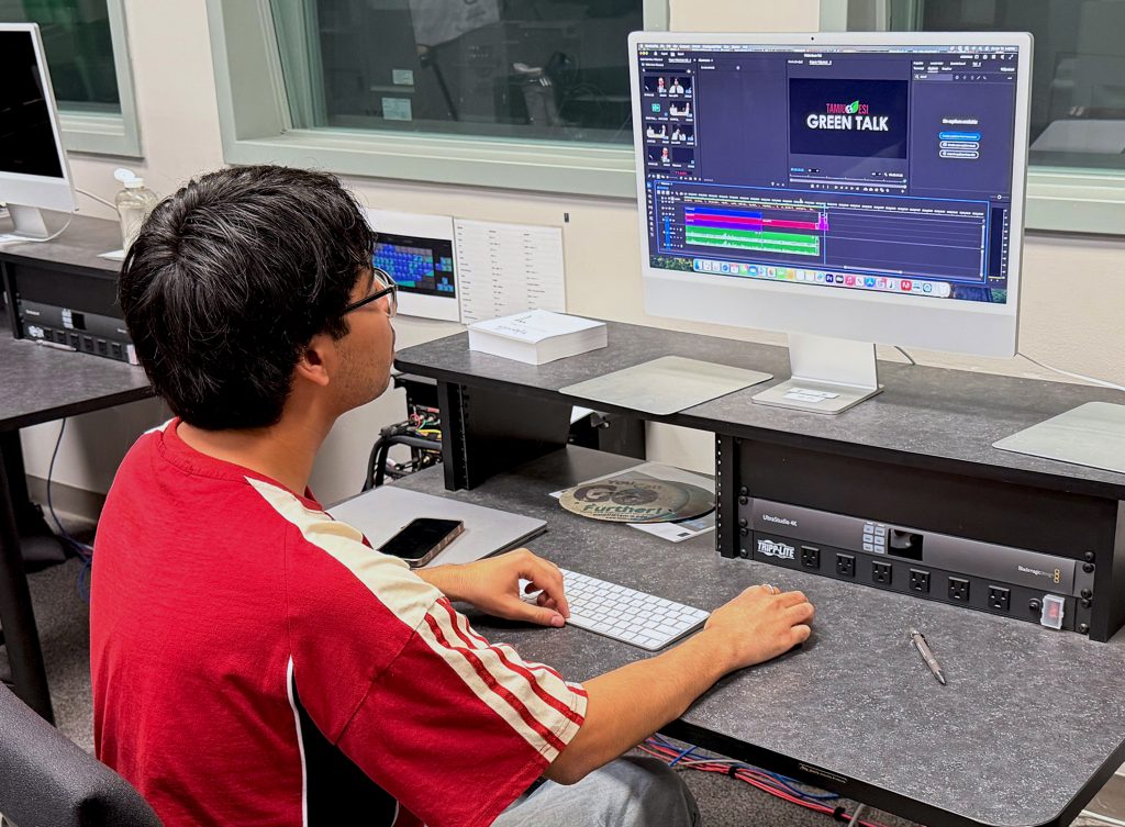 A student works on editing a podcast.