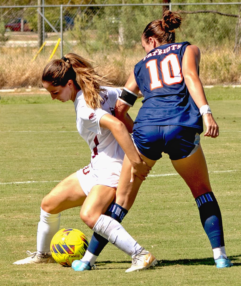 soccer players compete for control of the ball