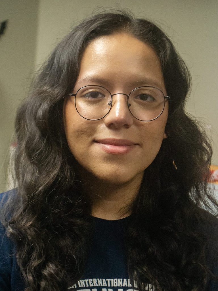 Portrait with dark hair and glasses.