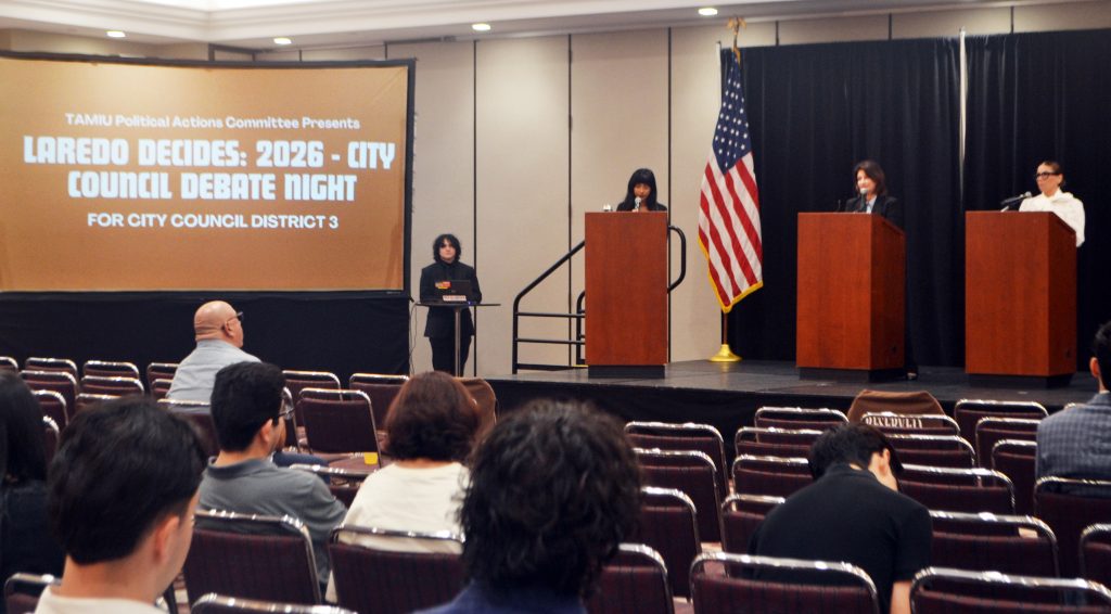 Attendees listen to the debate of city council contenders.