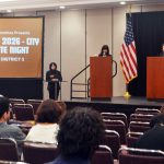 Attendees listen to the debate of city council contenders.